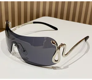 Detail of Y2K shield sunglasses showing the metallic snake element on the side frame