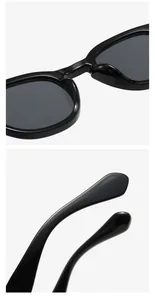 Detail view of black round frame sunglasses with integrated nose pads and wide temple tips