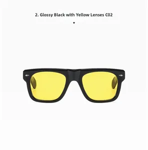 Close-up of glossy black square sunglasses frame with transparent yellow lenses and silver rivets
