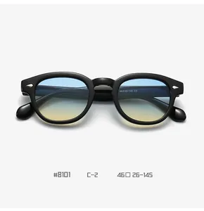 Detail view of round sunglasses frame with silver arrow rivets and blue-yellow gradient lens