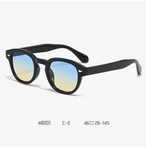 Detail view of retro round sunglasses with black frame and blue-yellow gradient lenses