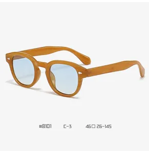 Detail view of round vintage glasses with light wood grain frame and silver arrow studs