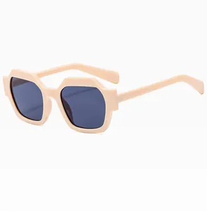 Detailed side view of geometric polygon sunglasses in beige with thick plastic frames