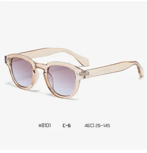 Close-up of champagne round frame sunglasses with purple to blue gradient lenses