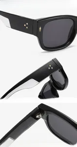 Detailed view of black sunglasses featuring golden star rivets and UV protection lenses