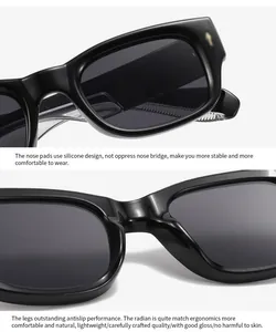 Detail of comfortable silicone nose pads and sleek black frame with golden metal rivets