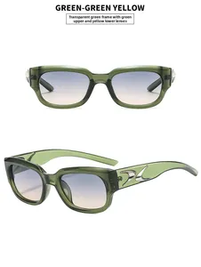 Detailed view of green frame sunglasses with silver flame metal trim and gradient lenses