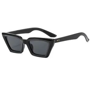 Vintage cat-eye sunglasses with thick black frame and golden star rivets on pure background