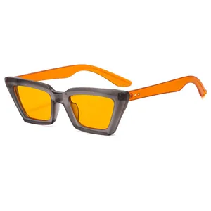 Retro cat-eye sunglasses with translucent grey frame and vibrant orange lenses