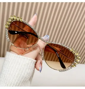 Détail de lunettes de soleil de luxe en métal avec strass blancs et pierres jaunes marquise