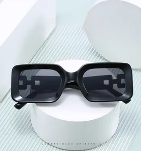 Detail showing chain-style geometric cutout on the temple of black rectangle sunglasses