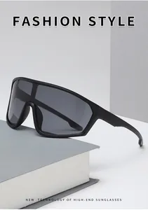 Detailed side view of black shield cycling sunglasses with matte frame on a grey surface