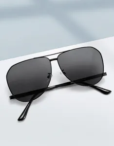 Detail view of metallic pilot sunglasses showing size 63-11-141 engraved on inner temple