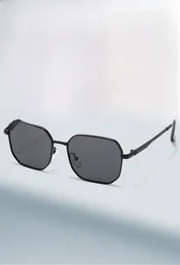 Detail view of hexagonal black frame sunglasses with dark grey sun protection lenses