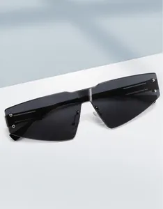 Detail of rimless shield sunglasses with grey lenses and silver stud accents