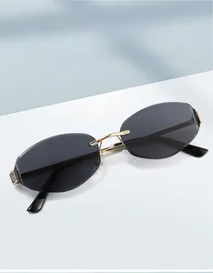 Detailed view of rimless oval sunglasses with gold FF metal hinge and grey lenses
