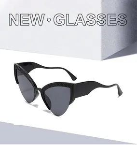 Detail of black cat eye sunglasses showing honeycomb texture and wave-shaped wide temples