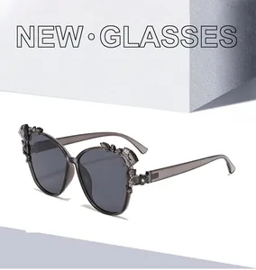 Detail of gray translucent sunglasses frame featuring faceted crystal embellishments