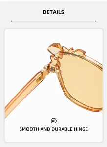Detailed close-up of smooth durable metal hinge on amber crystal floral sunglasses