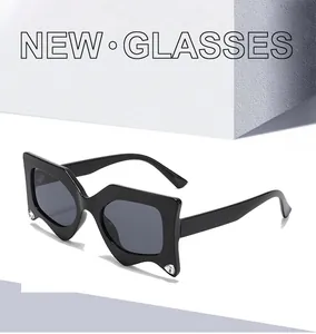 Detail of black geometric sunglasses featuring sparkling rhinestone accents on the frame