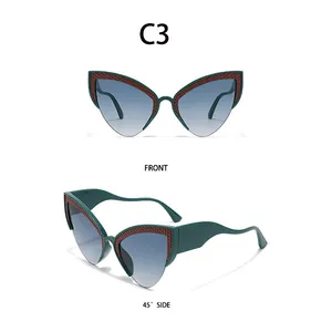 Detail view of cat eye sunglasses with dark green frames and wavy textured decorative accents
