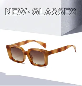 Detail of square amber tortoiseshell sunglasses frame with brown gradient lenses