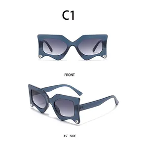 Detailed views of blue geometric butterfly sunglasses with gradient lenses and rhinestone accents
