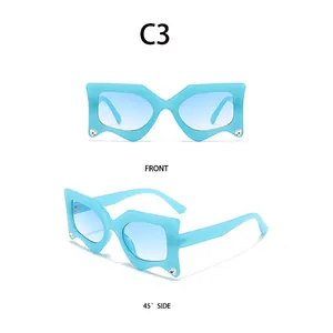 Macro view of C3 irregular blue gradient sunglasses with rhinestone accents