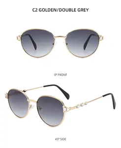 Détail de lunettes de soleil dorées rondes avec diamants et verres gris dégradés