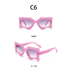 Detail of pink geometric wave sunglasses with rhinestones and purple gradient lenses