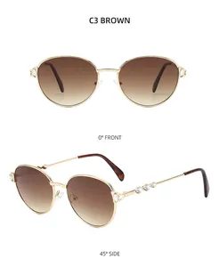 Détail de lunettes de soleil rondes en métal doré avec cristaux et verres dégradés bruns