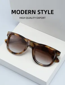 Detail of leopard print sunglasses with brown gradient lenses and metal rivets