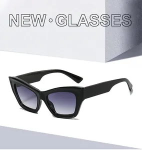 Detail of cat eye sunglasses with thick black frame and purple gradient lenses