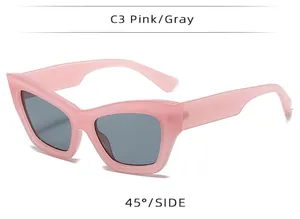 Pink chunky cat eye sunglasses with gray lenses shown from a 45-degree side angle view