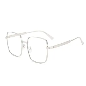 Modern oversized square metal sunglasses with silver frame and engraved geometric patterns