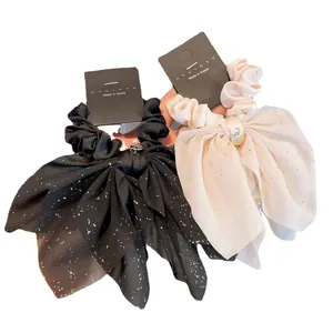 Sparkly star bow scrunchie set in black and white with metal charms and wide streamers