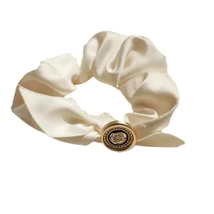 French vintage white satin scrunchie with a gold rose decorative buckle detail