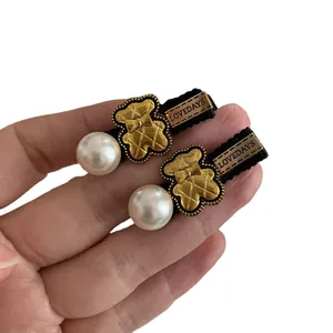 Golden bear hair clips with large pearls and black fabric wrap for girls