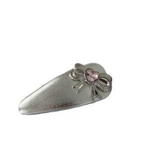 Silver bow hair clip with pink heart crystal in minimalist waterdrop design