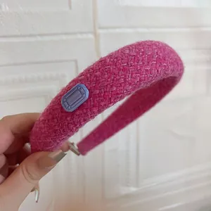 Detail of pink tweed headband with rectangular blue gemstone accent for women