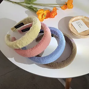 Detail of pleated sponge headbands in candy colors with handmade inner label