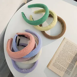 Close-up of colorful thick sponge headbands with handmade labels and fabric texture