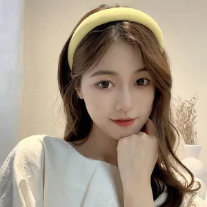 Close-up of yellow sponge headband with soft knit fabric on female model