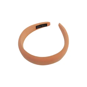 Thickened sponge headband in peach pink fabric with textured mesh and handmade label