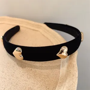 Elegant black velvet headband for women with golden heart-shaped metal accents