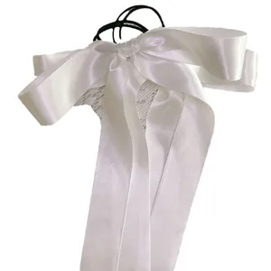 White satin bow hair tie with lace details and long ribbons in balletcore style