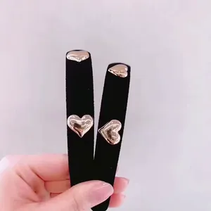 Detailed macro view of black velvet headband with elegant rose gold heart-shaped ornaments