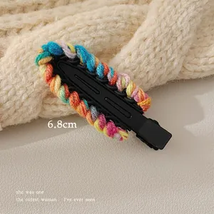 Detailed view of a 6.8cm colorful knitted wool hair clip with a black metal base clip