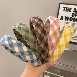 Plaid padded headbands in various colors featuring thick sponge design and fabric texture