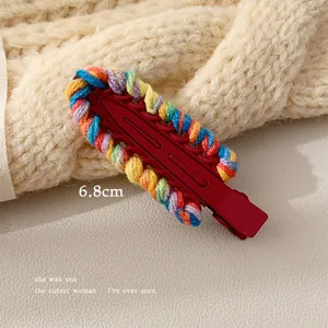 Detailed view of 6.8cm colorful hand-woven yarn hair clip with rainbow knit patterns